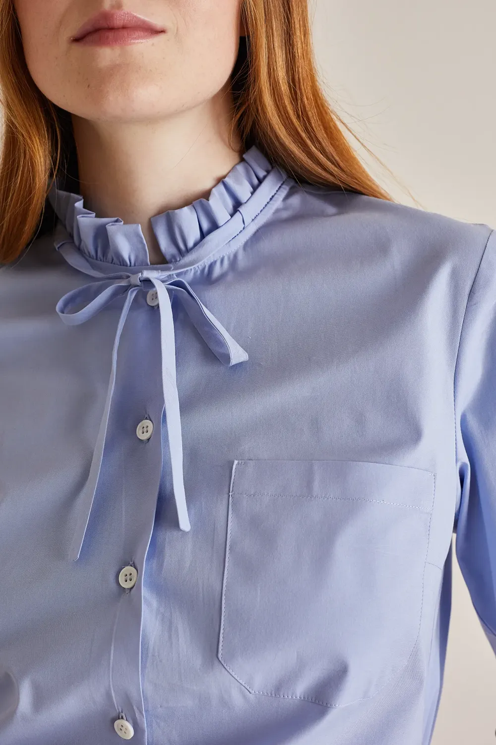 Shirt with ruffled collar and ribbon