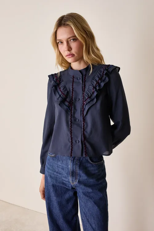 Shirt with ruffles and velvet accents

