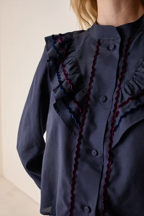 Shirt with ruffles and velvet accents
